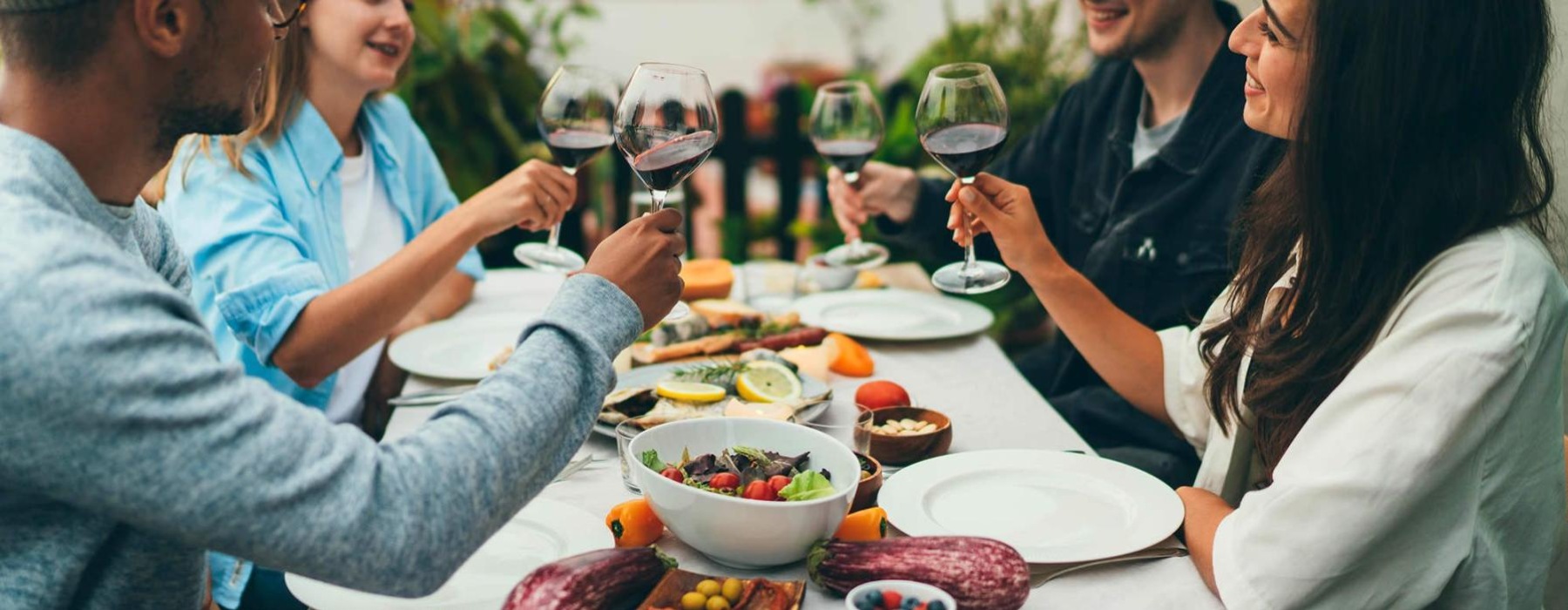 a group of people toasting together at a table