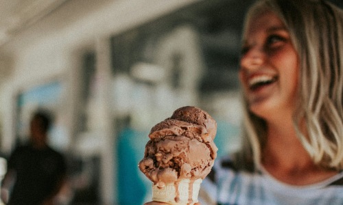 a woman holding an ice cream cone a woman holding an ice cream cone